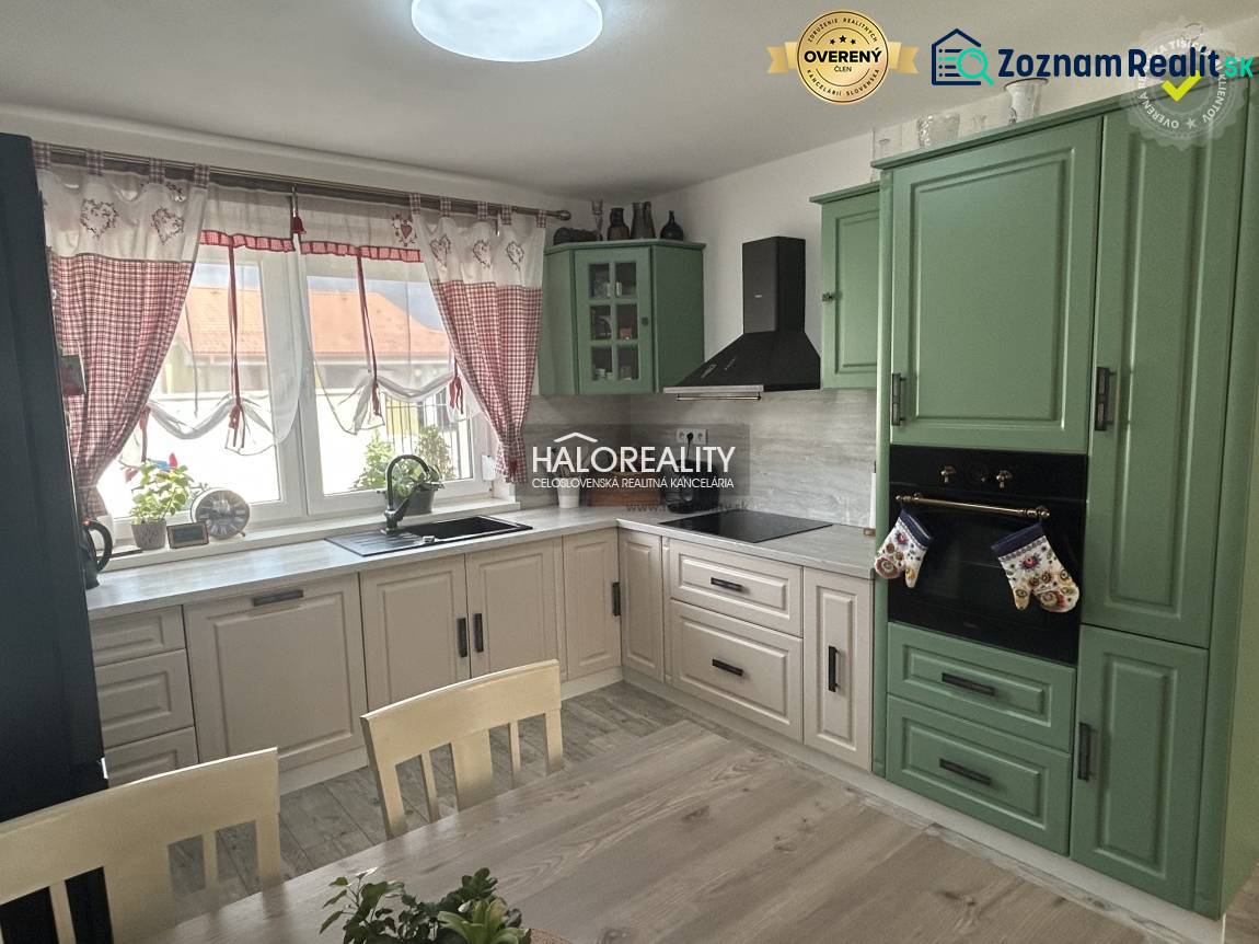 Konyha családi házban fa bútorokkal és függönyökkel.