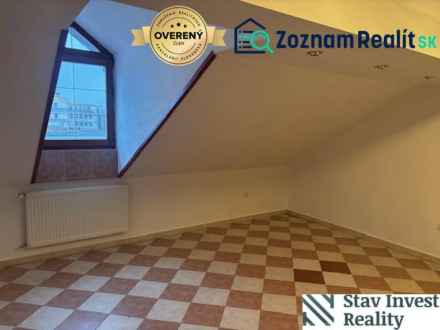 Tetőtéri iroda padlóburkolattal és ablakkal, radiátoros fűtéssel.