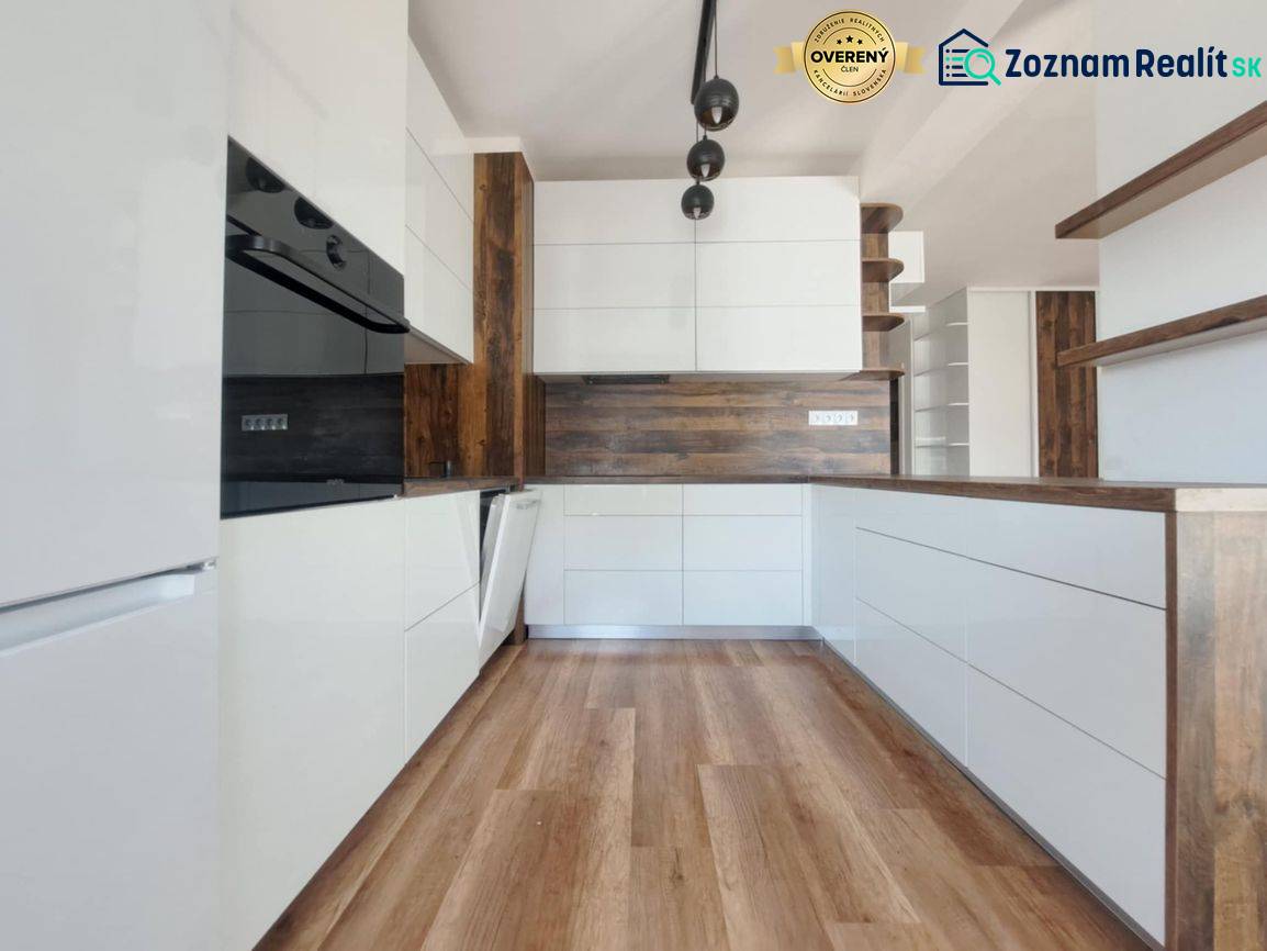 Konyha egy kétszobás lakásban fehér szekrényekkel és fa dekor padlóval.