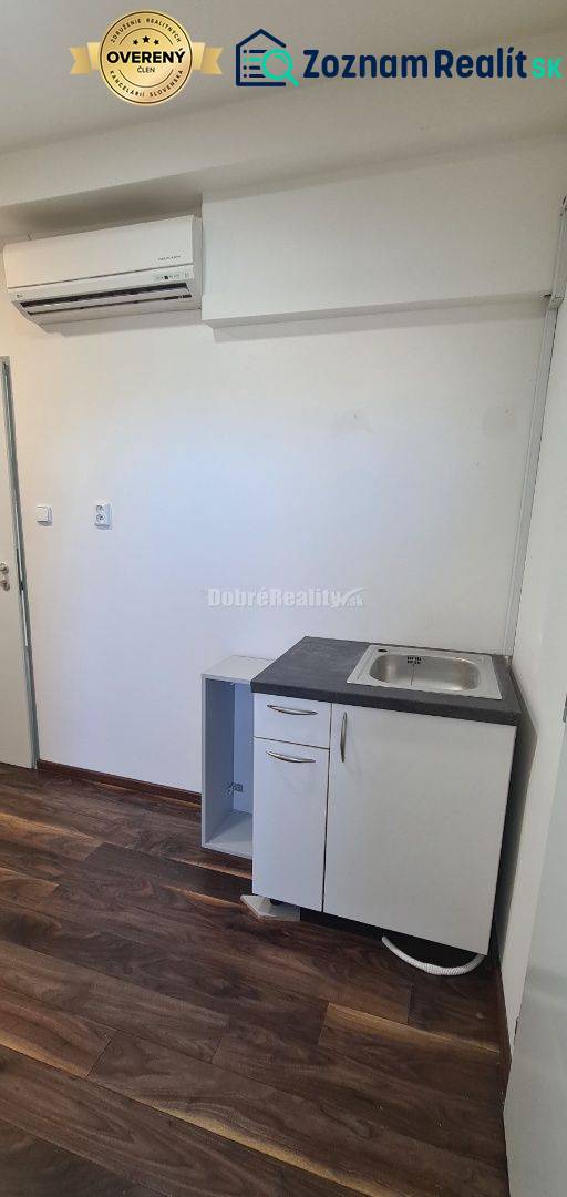 Iroda légkondicionálóval, mosdóval és fa dekorációjú padlóval.