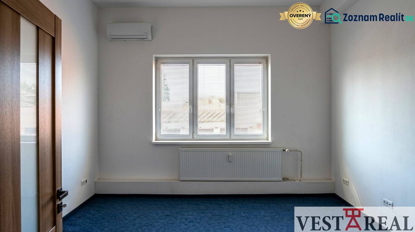 Légkondicionált szoba ablakkal az irodákban, kék szőnyeg, fehér falak.