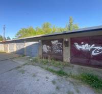 Garázsok Zólyomban, graffiti a kapukon, zölddel és betonfelülettel körülvéve.