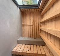 Fából készült belső tér a házikóban, kilátással a természetre a nagy ablakon keresztül.