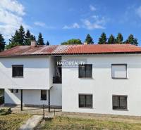 Családi ház piros tetővel és fehér homlokzattal Selmecbányán.