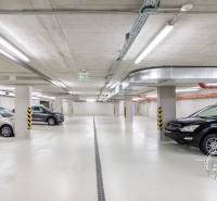 Parkolóhelyek a garázsokban parkoló autókkal, világítási és szellőztető rendszerek.