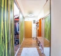 Előszoba egy kétszobás lakásban, fa mintázatú padlóval és cipősszekrénnyel.