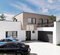 Egy földszintes családi ház, garázzsal és két autóval, zöldövezetben.