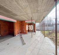 Családi ház építése tégla falakkal tágas telken a természetben.