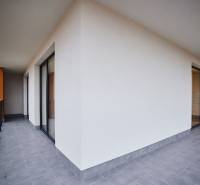 Tágas erkélyű, 2 szobás lakás csempével és üvegkorláttal.