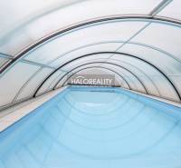 Fedett medence családi házban Domanižában íves szerkezettel.