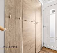 Előszoba beépített szekrénnyel és fehér ajtókkal egy háromszobás lakásban.