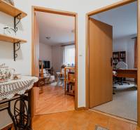 3 szobás lakás belső tere dekoratív kerámiával, könyvespolccal és szobákba vezető bejárattal.