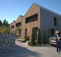 Családi házak Törökországban fa dekorációval, kőkerítéssel és parkoló autóval.