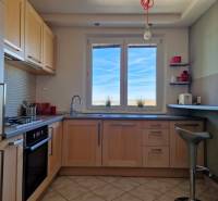 Konyha ablakkal, fa dekorációs padló, csempe, berendezés egy háromszobás lakásban.