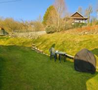 Családi ház kertje Selmecbányán bútordarabokkal és a környező természetes környezet jellegével.