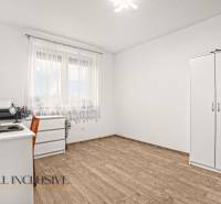 Szoba egy családi házban szekcióbútorral és fa dekoros padlóval.