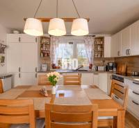 Konyha családi házban fa dekorációval és étkezőasztallal.