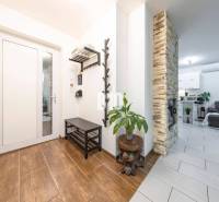 Családi ház belső tere fa dekoros padlóval, kő kandallóval és kényelmes nappalival.