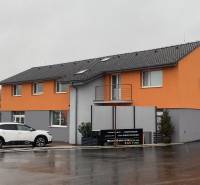 Épület üzlethelyiségekkel és parkoló autóval a Nyitrai Štúrova utcában.