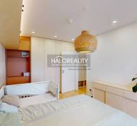 Gyerekszoba ággyal, rattan lámpával és ruhásszekrénnyel egy háromszobás lakásban.