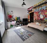 Gyerekszoba családi házban, graffiti a falon és fa dekorációjú padló.