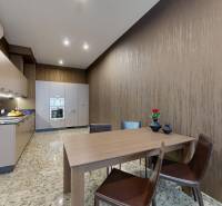 Konyha egy háromszobás lakásban étkezőasztallal, beépített készülékekkel és stílusos székekkel.