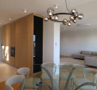 Egy 4 szobás lakás belső tere kanapéval, üvegasztallal és fa dekorációjú padlóval.