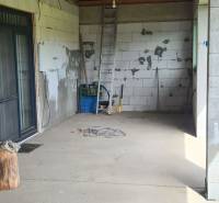 Egy családi ház belső tere ízléstelen falakkal, létrával és építőanyaggal.