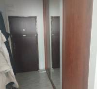 Folyosó csempével és nagy tükörrel a garzonlakásban.