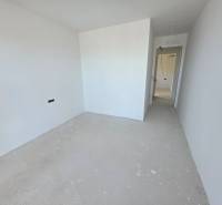 Nyaraló apartman fehér falakkal és alapvető padlóval dekoráció nélkül.