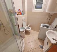 Fürdőszoba a nyaraló apartmanban WC-vel, zuhanyzóval és mosógéppel.