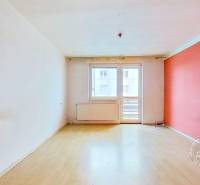 Háromszobás lakás szobája fa dekoros padlóval és erkéllyel.