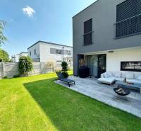 Családi ház Rovinkában terasszal, zöld gyepfelülettel és kerti ülőhellyel.