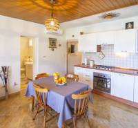 Konyha a nyaraló apartmanban fa dekor padlóval és étkező sarokkal.