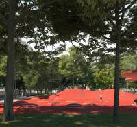 Park piros játszótérrel a Golianova utcában, Trnava, fákkal és padokkal körülvéve.