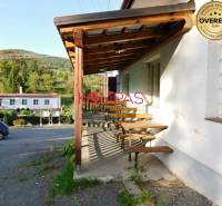 A Vígľašská Huta-Kalinkai üzlethelyiség fa terasza, parkoló, környező természet.