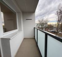 A komáromi Košická utcai 3 szobás lakás erkélye parkolóra és fákra néző kilátással.