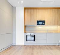 Konyhabútor a konyhai készülékek a kétszobás lakásban, fa dekorációjú padlóval.