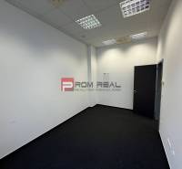 Irodák fehér falakkal és sötét szőnyeggel.