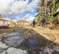 Családi ház Bobot községben, Bobot utcában, betonfelülettel és fákkal a kertben.