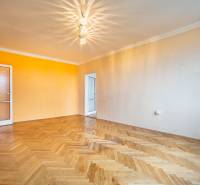 Világos szoba fa mintás padlóval egy kétszobás lakásban, színes falakkal.