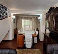 Ebédlő fa bútorokkal és fa dekorációjú padlóval egy családi házban.