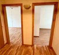 Folyosó két szobába nyíló bejárattal, fa dekorációjú padlóval egy kétszobás lakásban.