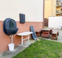 Kert a Hodža utcában, Trencsénben, padokkal és kerti bútorokkal egy 2 szobás lakás mellett.