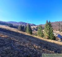 Gyönyörű hegyi környezet Hroncon rétekkel és házzal lakóterületeken.