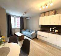 Konyha és nappali egy kétszobás lakásban fa dekor padlóval.