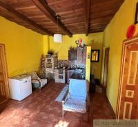 Családi ház belső tere fa mennyezettel és sárga falakkal.