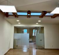 Iroda belső tér fa dekor padlóval és üvegajtókkal.