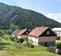 Családi házak Liptovské Revúcéban hegyi tájjal és kertekkel.