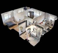 3D alaprajz egy háromszobás lakásról fa mintázatú padlóval és berendezéssel.